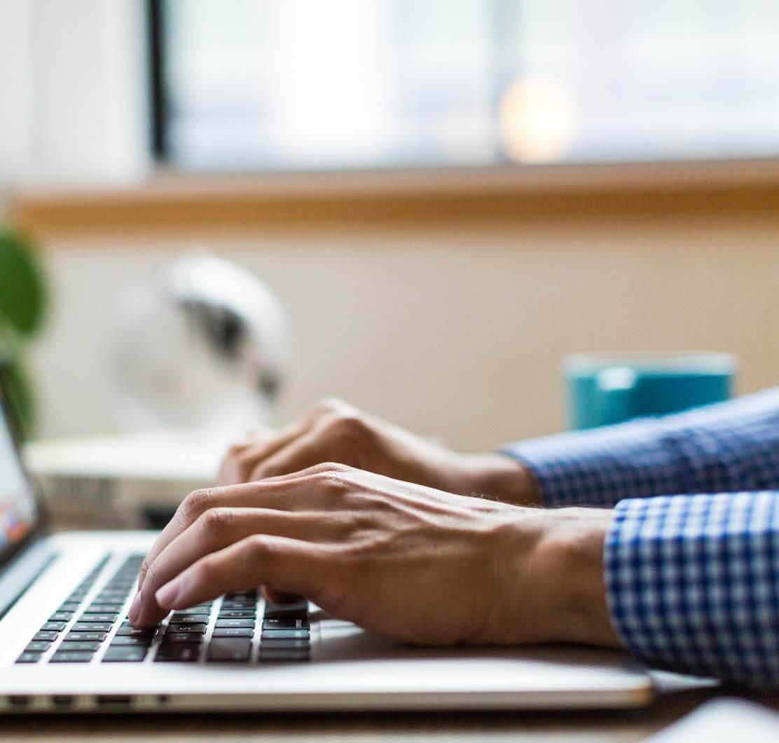 hands typing on a computer